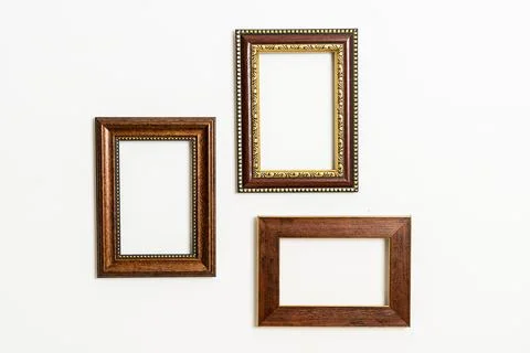 Empty picture frame on white wall background Stock Photos