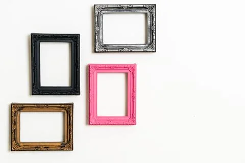Empty picture frame on white wall background Stock Photos