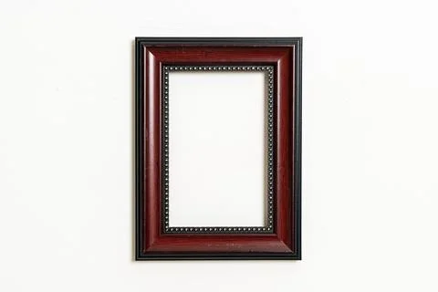 Empty picture frame on white wall background Stock Photos