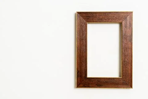 Empty picture frame on white wall background Stock Photos