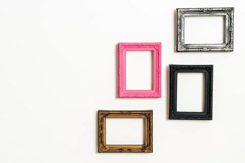 Empty picture frame on white wall background Stock Photos