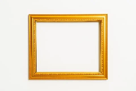 Empty picture frame on white wall background Stock Photos