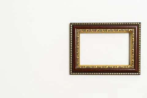 Empty picture frame on white wall background Stock Photos