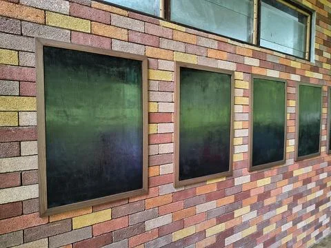 Empty picture frames on colorful brick wall with perspective view Stock Photos