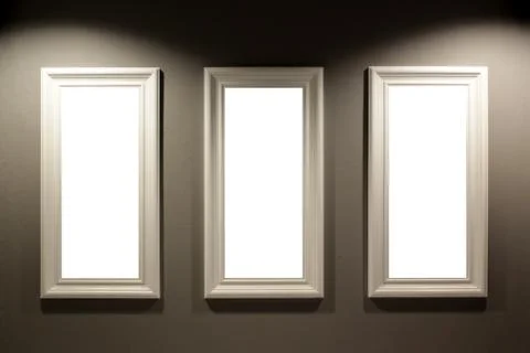 Empty picture frames on the wall with lighting Stock Photos