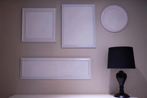 Empty picture frames on the walls of the room and vases for decorating the ro Stock Photos