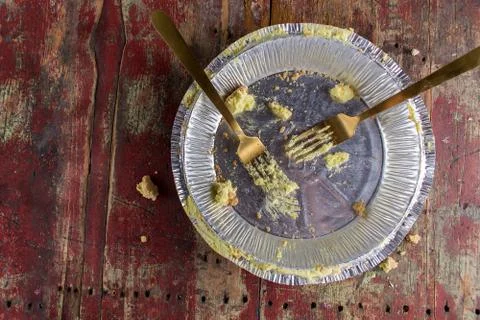 Empty pie tin with two forks on rustic wood table top view Stock Photos