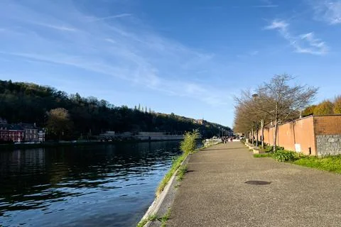 Empty pier alongside the Meuse river in Dinant, Belgium Stock Photos
