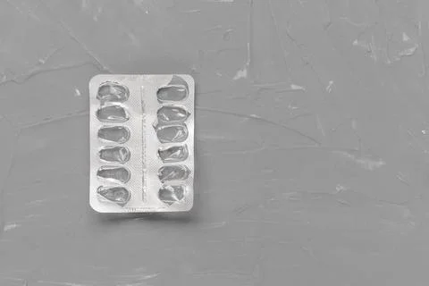 Empty pill blister on gray background, supplement concept Stock Photos