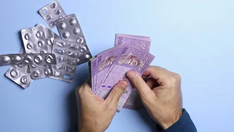 Empty pill blisters and man's hands counting Malaysian ringgit (MYR) banknotes. Stock Footage 303341998