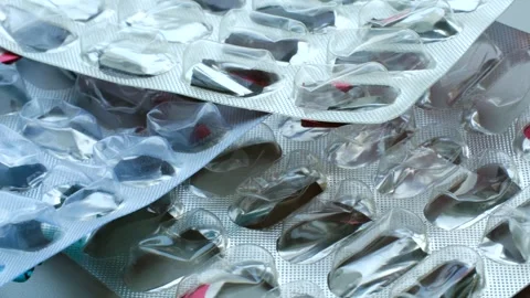 Empty pill blisters piled up on white background Stock-Footage 311941776