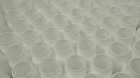Empty Pill Bottles being Queued for Filling Stock Footage 71455419