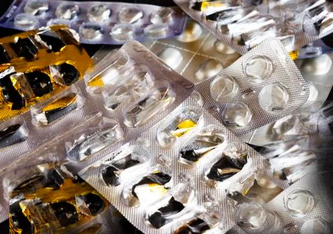 Empty pill boxes on the black table. Stock Photos