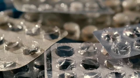Empty pills blister pack falling on the table Stock Footage 72721082