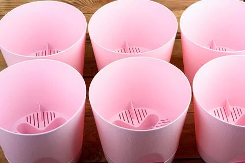 Empty pink plastic flower pots close-up. Stock Photos