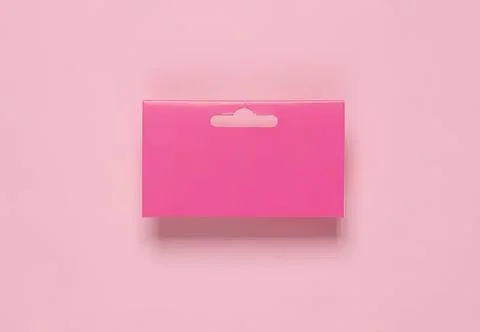 Empty pink retail packaging box on pink background Stock Photos