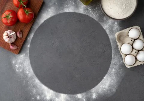 Empty pizza space with tomatoes, eggs and flour over stone background. Pizza  Stock Photos