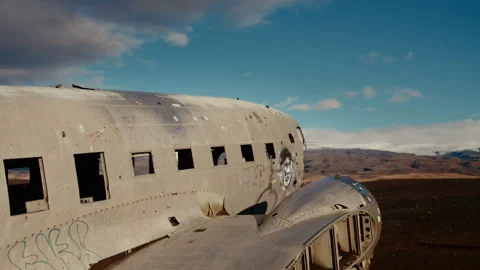 Empty plainwreck from the side, clouds annd mountains in the background Stock Footage 260954073