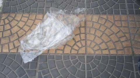 Empty plastic bag blowing on city sidewalk motion video footage Stock Footage 336288275