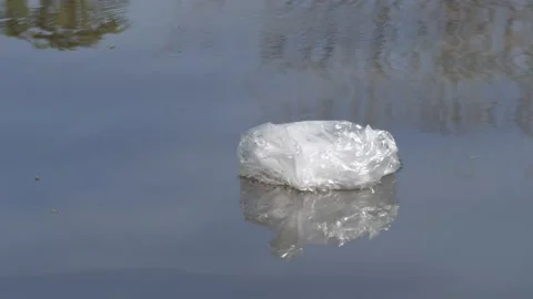 Empty plastic bag floating on the river Video stock 132351972