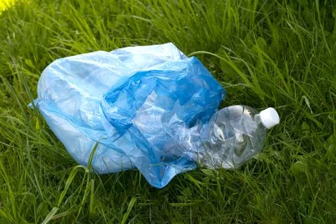 Empty plastic bottle are lying on the grass Stock Photos