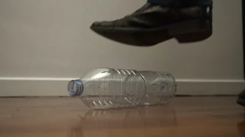 Empty plastic bottle crushed with cowboy boot Video stock 276737592