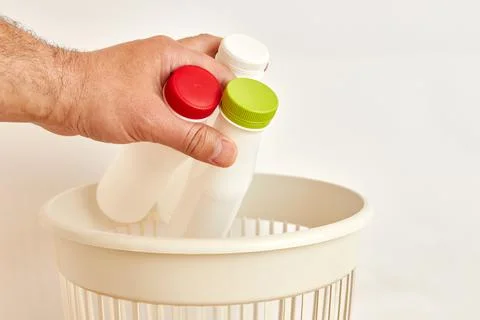 An empty plastic bottle is thrown away in a landfill for disposal and recycling Stock Photos