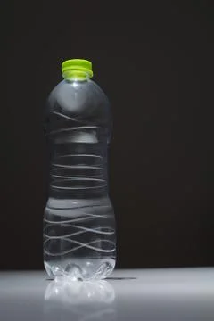 Empty plastic bottle in transparent PET on a dark background Foto stock