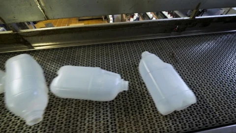 Empty plastic bottles canisters on the conveyor belt Stock Footage 128067534