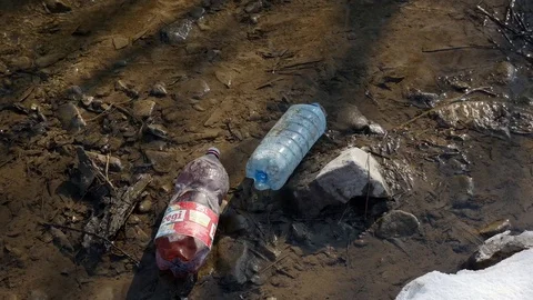 Empty plastic bottles in the clean small creek Stock Footage 104023705