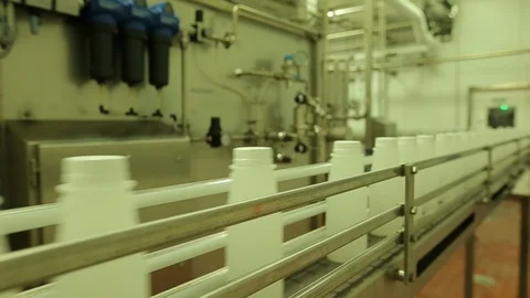 Empty plastic bottles. On conveyor belt in plant D Video stock 102185437