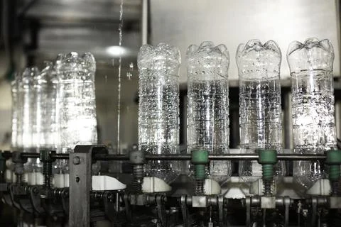 Empty plastic bottles on a conveyor Stock Photos