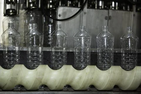 Empty plastic bottles on a conveyor Stock Photos