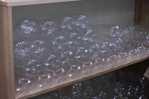 Empty plastic bottles for draft products sit on a shelf in a village shop. Stock Photos