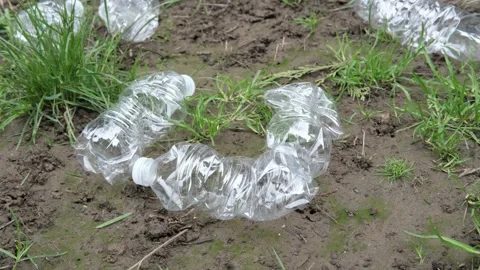 Empty plastic bottles laying the ground floor as trash and should be recycled. Video stock 332678965