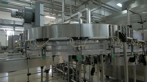 Empty plastic bottles move on automatic conveyor line or belt in water and juice Stock Footage 108970597