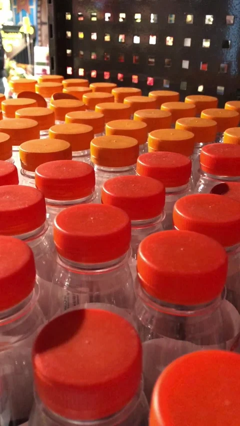 Empty plastic bottles with orange caps for fresh juice Stock-Footage 341683256