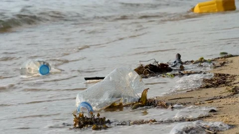 Empty plastic bottles on sand beach Stock Footage 149235087