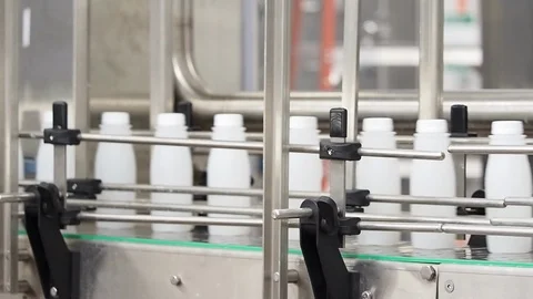 Empty plastic bottles. Traveling on conveyor belt in plant Stock Footage 101975963