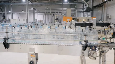 Empty plastic bottles for water transported by conveyor Stock Footage 160853028