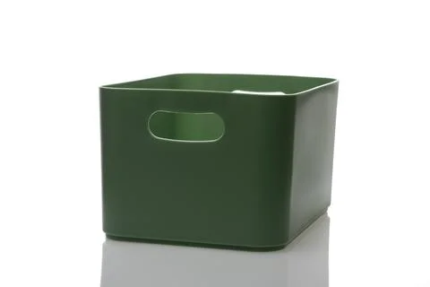 An empty plastic box of green color is isolated on a white background, Stock Photos