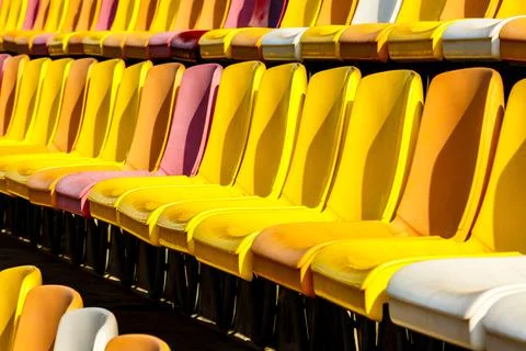 Empty plastic chairs in the stadium. Stock Photos
