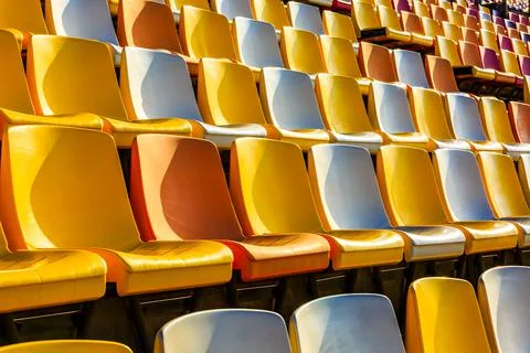 Empty plastic chairs in the stadium. Stock Photos