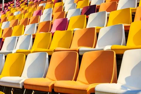 Empty plastic chairs in the stadium. Stock Photos