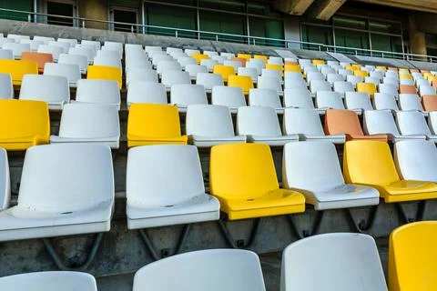 Empty plastic chairs in the stadium. Stock Photos