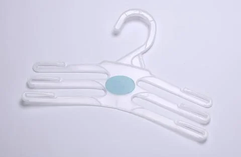 Empty plastic clothes hanger on a plain white background Stock Photos