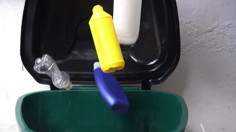 Empty plastic containers and packaging fall into the trash Stock Footage 111584115