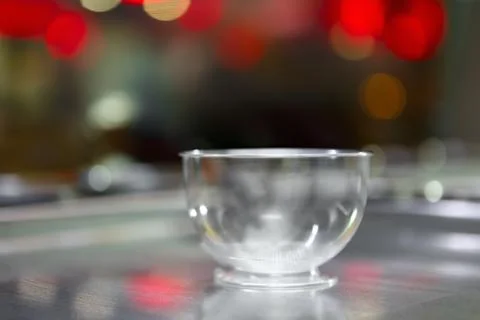 Empty plastic cup for a sweet ice cream dessert on a background of bright gla Stock Photos