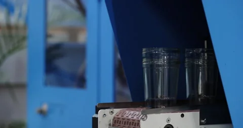 Empty plastic cups organized and transported by automated equipment Stock Footage 341863990
