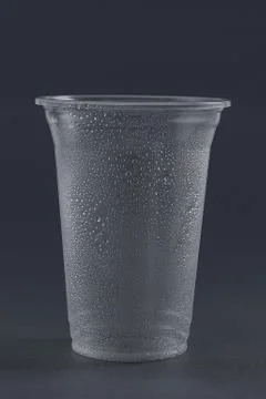Empty plastic glass on a gray background. Stock Photos
